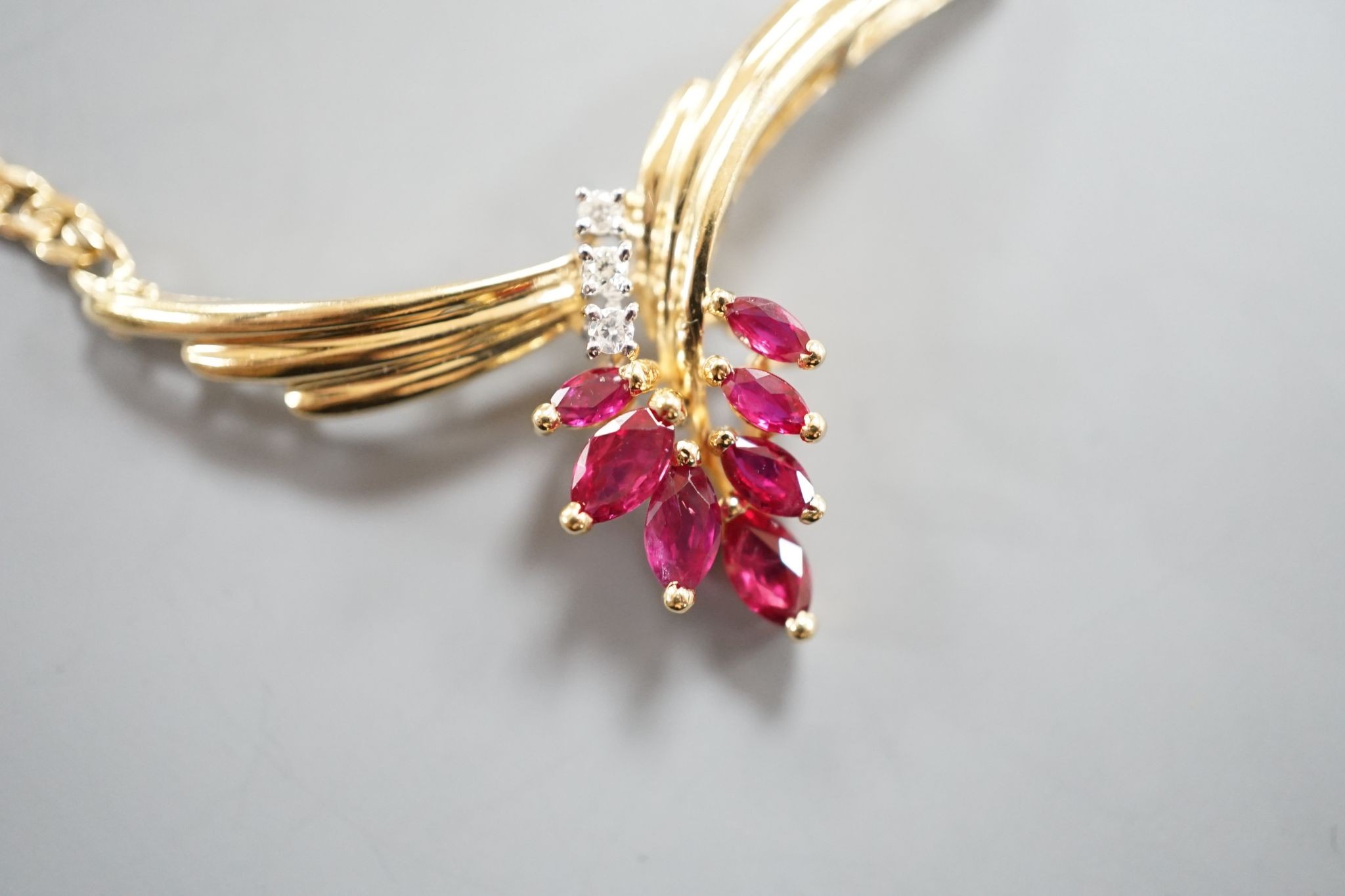 A modern 585 yellow metal, ruby and diamond cluster set pendant necklace, 44cm